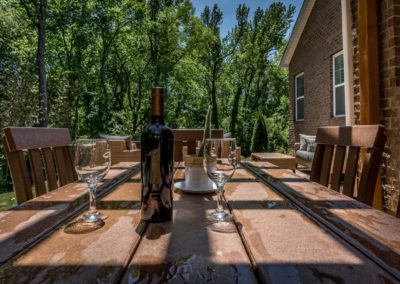 Table with wine glasses to enjoy the outdoor living experience in Charlotte NC