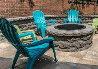 Fire Pit with chairs on a patio by Benton Outdoor Living