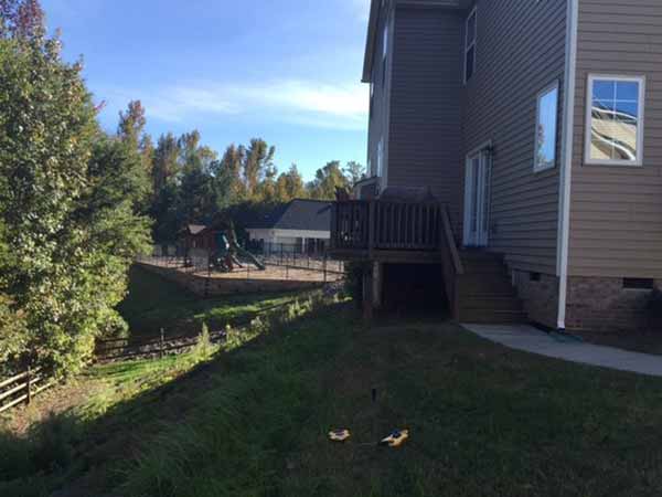 Fort Mill home with sloping yard on side and back before Benton Outdoor Living