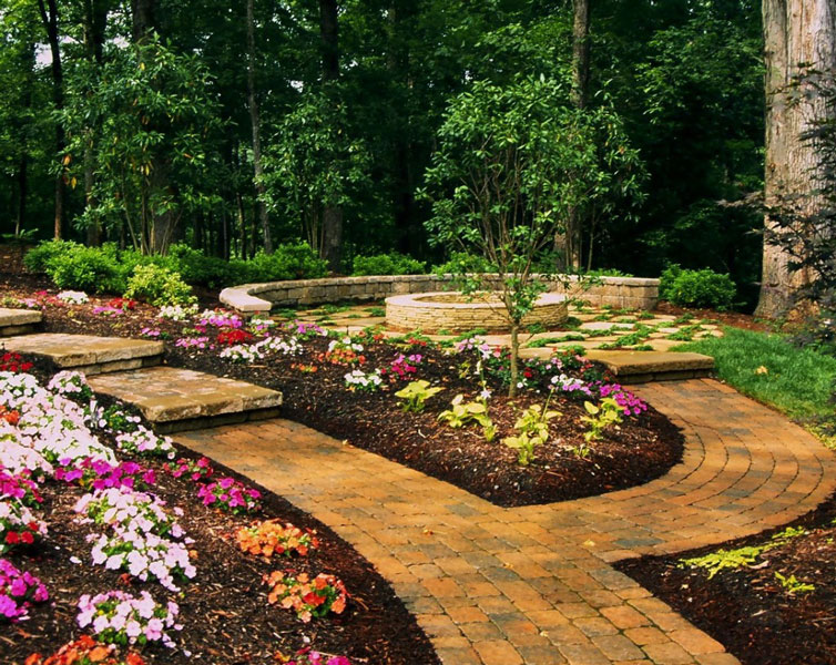 paver walkway that goes through a Charlotte area backyard and branches off to a fire pit by Benton Outdoor Living