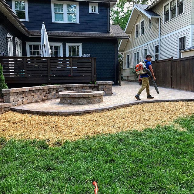 Charlotte backyard after Benton Outdoor Living installed a paver patio, fire pit and seating wall.