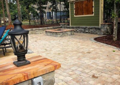 Fort Mill backyard with Paver Patio, fire pit and outdoor TV cabinet installed by Benton Outdoor Living