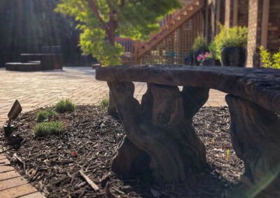 Wood Bench area overlooking a large patio area.