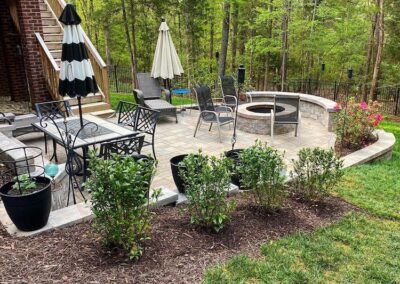 Backyard patio in Lake Wylie with paver patio, seat wall and fire pit by Benton Outdoor Living