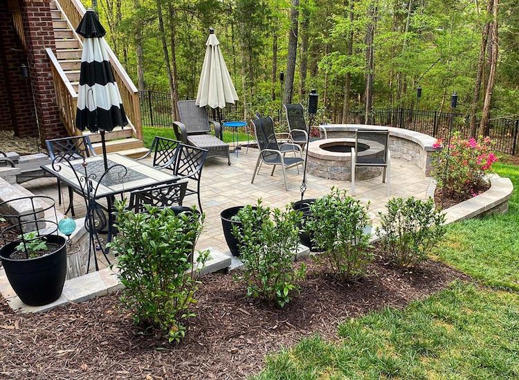 Backyard patio in Lake Wylie with paver patio, seat wall and fire pit by Benton Outdoor Living