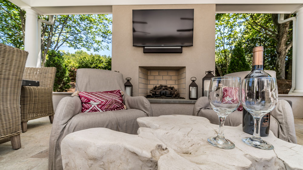Outdoor Fireplace with TV set mounted above it.