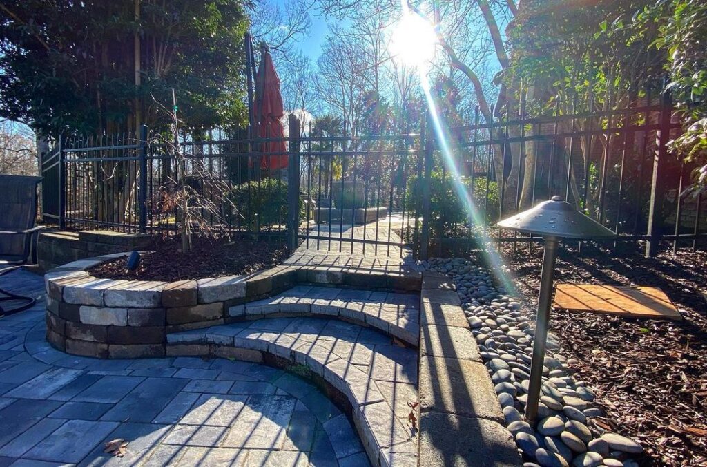 Patio with landscape lighting along the side of it