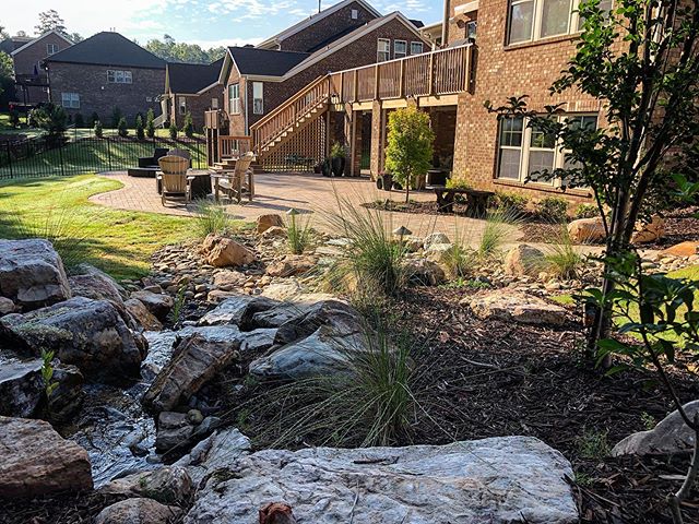 Natural and rock area in yard that adds beauty and is an alternative to grass lawns